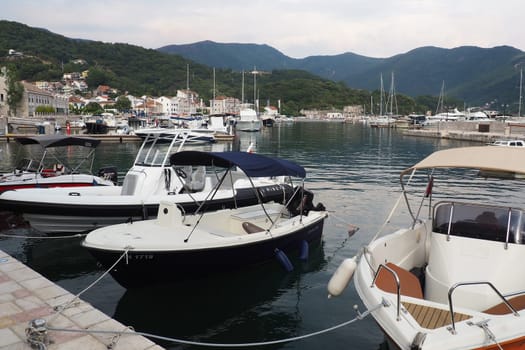 Meljine, Herceg Novi, Montenegro, August 13 2022 Boats, yachts and ships are at anchor. Moored ships in the parking lot. Adriatic Sea Mediterranean. Travel business. Sea travel and sports. Summertime