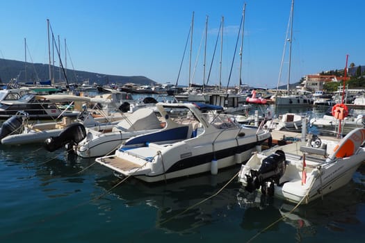 Meljine, Herceg Novi, Montenegro, August 13 2022 Boats, yachts and ships are at anchor. Moored ships in the parking lot. Adriatic Sea Mediterranean. Travel business. Sea travel and sports. Summertime
