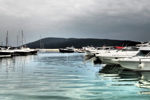 Meljine, Herceg Novi, Montenegro, August 13 2022 Boats, yachts and ships are at anchor. Moored ships in the parking lot. Adriatic Sea Mediterranean. Travel business. Sea travel and sports. Summertime