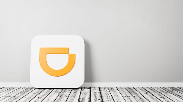Didi App Icon 3D Symbol Shape on Wooden Floor Against Gray Wall with Copy Space 3D Render Illustration