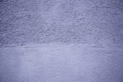 Detail of rough cement wall painted blue, exterior decoration