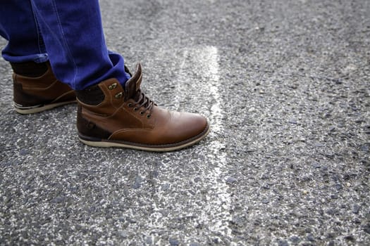 Detail of young man on a road for cars