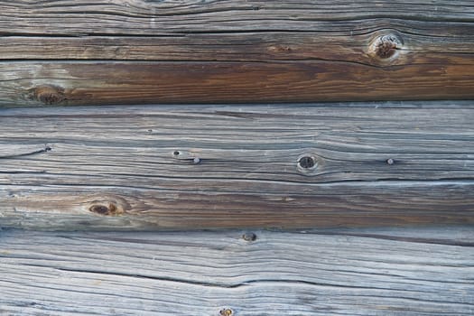 Background horizontal logs. Wooden background from shabby boards and logs. Round lumber assortment. General purpose lumber. Special type of forest products. Knots and branches
