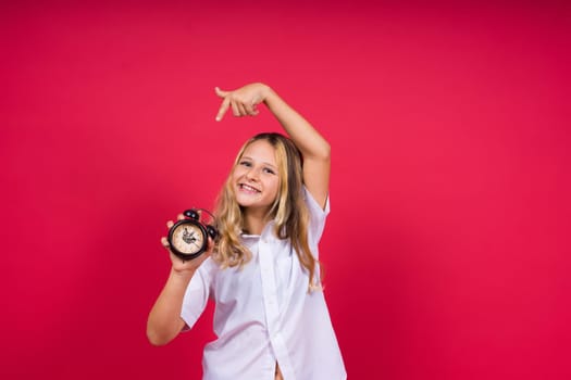 Teen girl 12, 13, 14 years old look alarm clock. Good morning, checking time. Positive emotions.