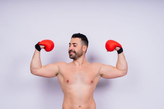 Young caucasian handsome man isolated on a white background with boxing gloves