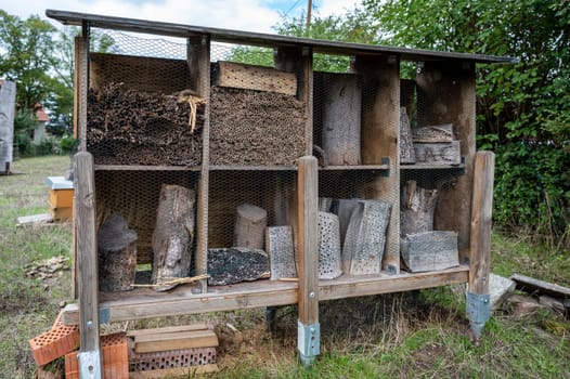 Apiary bee home bee hotel, insect hotel agricultural environmental Protection made of wood at a farm