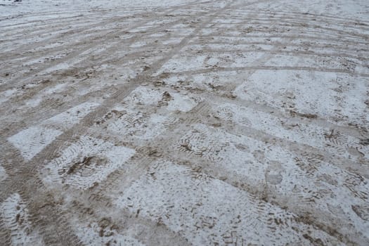 Snow, ice, slush and winter mud at a pedestrian crossing. The air temperature is about 0. Difficult driving conditions. Braking distance of the car. Traffic Laws. Infrastructure and road services.