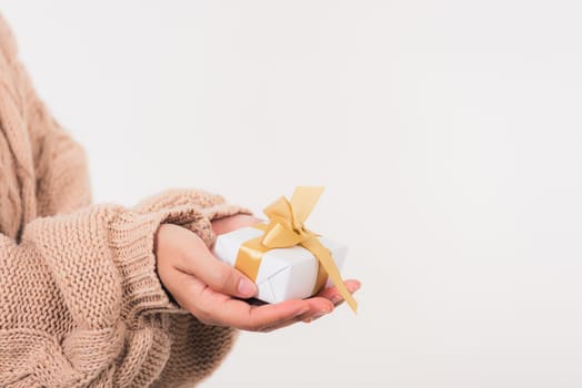 Valentine Day. Woman beauty hands holding small gift package box present wrapped paper with ribbon, Christmas, New year, Birthday holiday background concept