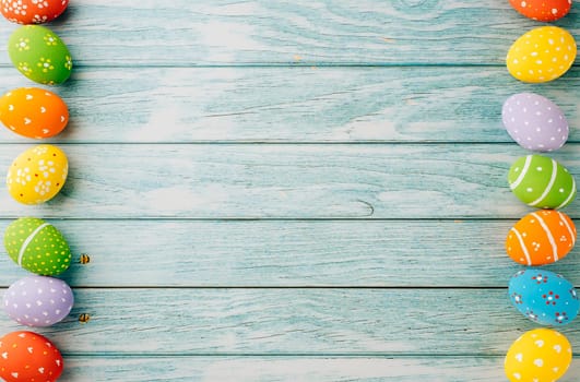Easter Day Concept. Top view holiday banner background web design white colorful easter eggs painted on blue wood background with empty copy space, celebration greeting card, overhead, template