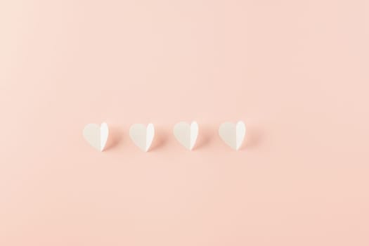 Happy Valentines Day background. Top view flat lay of paper elements cutting white hearts shape flying on pink background with copy space, Happy Mother's Day, Banner template design of holiday