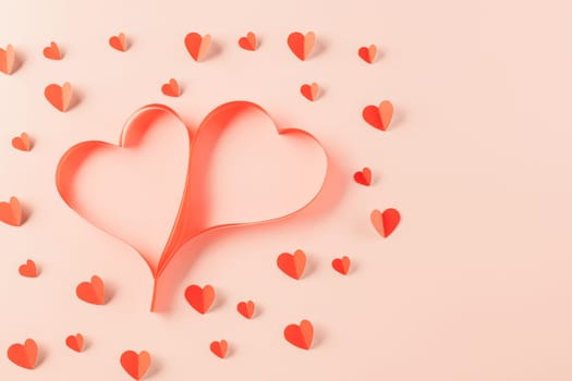 Top view flat lay of Ribbons shaped as heart and paper elements cutting red hearts flying on pink background, Banner template greeting card design of holiday, Love and Valentines Day background