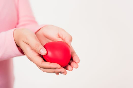 Love Valentine's Day. Female beauty hands holding modern a red heart isolated on white background, giving help donation medical healthcare happy holiday background concept