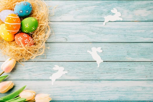 Top view holiday banner background web design white easter eggs in brown nest on blue wooden background with empty copy space, celebration greeting card, overhead, template, Happy Easter Day Concept