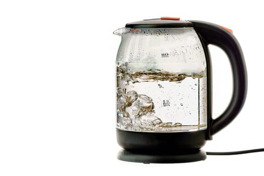 Glass electric kettle with boiling water on a white insulated background. High quality photo