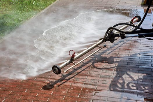 A special machine washes city paths and roads with water. High quality photo
