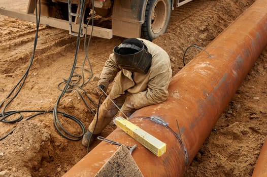 The welder welds the pipe by electro welding. High quality photo