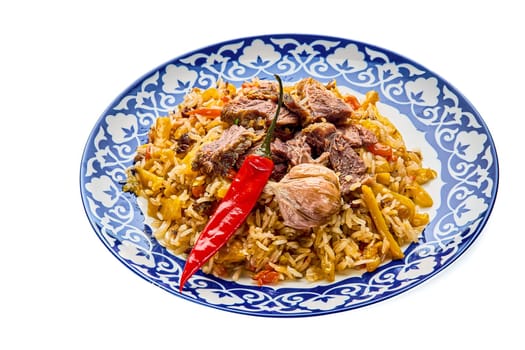 Delicious Uzbek festive pilaf in a plate on a white isolated background. High quality photo