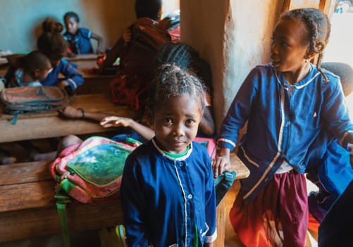 Vohitsaoka, Ambalavao, Madagascar - November 17. 2022: Happy Malagasy school children students in classroom. School attendance is compulsory, but many children do not go to school.