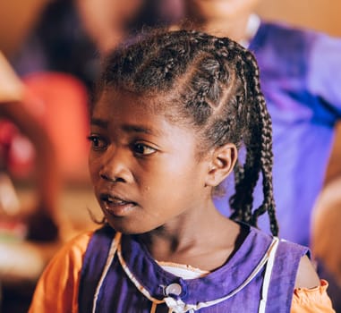 Vohitsaoka, Ambalavao, Madagascar - November 17. 2022: Happy Malagasy school girl, students in classroom. School attendance is compulsory, but many children do not go to school.