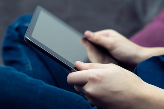 Close up cropped male hands using digital tablet with black screen. Online video games as leisure activity. Mobile applications and streaming entertainment. Electronic gadgets, chatting with friends