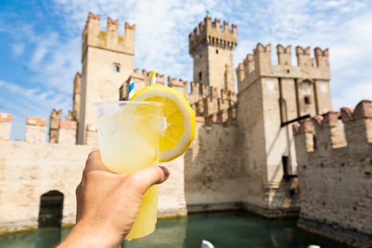 Hand with fresh cold lemonade. Concept for enjoy, relaxation, travel, summer