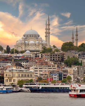 Istanbul city view at Eminonu overlooking the Golden Horn with ferries, ferry terminals, and Suleymaniye Mosque before sunset, Istanbul, Turkey