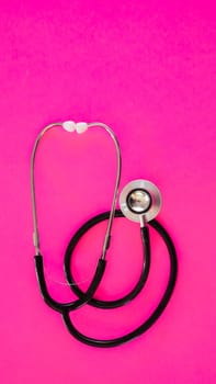 Stethoscope isolated on pink background with copy space