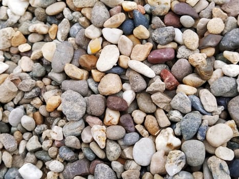 Pebbles as a background image. White, gray, brown, reddish small stones or pebbles