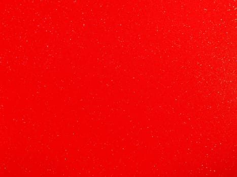 Red background, arched scarlet. Nice holiday color. Background with shimmer, gradient, white dots. Photograph of sparkling colored paper