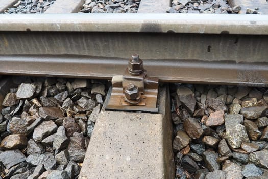 Railways. Metal steel rails and wooden sleepers. Rivets and fasteners on the railroad. Stony backfill of railway tracks. Station Nyrki, Karelia