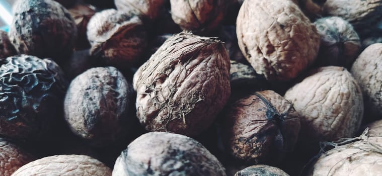 Walnuts close-up. Harvest of nuts. Walnut fruits, rounded large single single-seeded drupes. A healthy diet that includes glycerides of linoleic, oleic, stearic, palmitic and linolenic acids. Soft focus