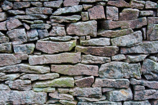 Closeup on a dry stone wall in yorkshire countryside, UK. Building materials pattern