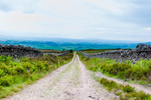 Empty lane with stone fences in Lancashire countryside, UK