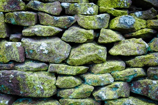 Closeup on a dry stone wall in yorkshire countryside, UK. Building materials pattern