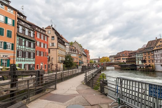 Strasbourg, water canal in Petite France area. timbered multicolored houses and trees in Grand Ile. Alsace, France.