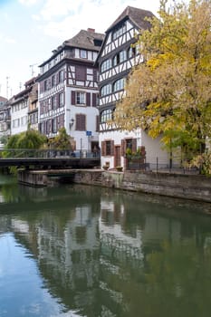 Strasbourg, water canal in Petite France area. timbered houses and trees in Grand Ile. Alsace, France.