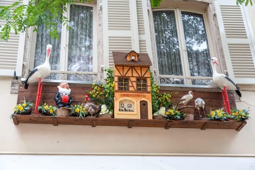 The originally decorated window in Strasbourg, France. storks and flowers
