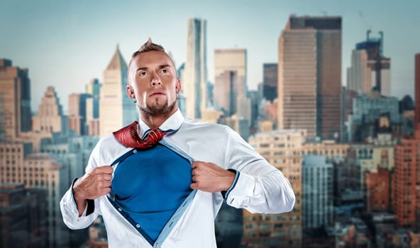 businessman acting like a super hero and tearing his shirt off against the background of Manhattan skyscrapers