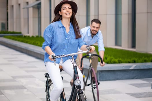 Romantic date of young couple on bicycles at street