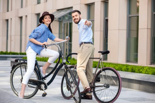 Romantic date of young couple on bicycles at street