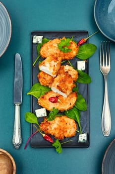 Baked chicken meat in breadcrumbs, chicken breast. Chicken cutlet in a breaded