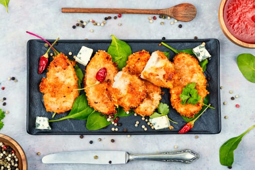 Baked chicken meat in breadcrumbs, chicken breast. Chicken cutlet in a breaded