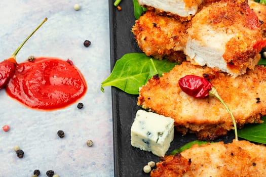 Baked chicken meat in breadcrumbs, chicken breast. Chicken cutlet in a breaded
