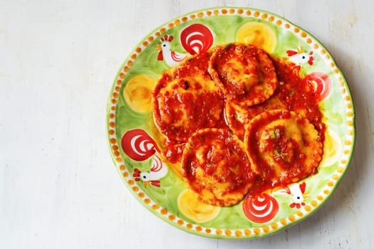 close up of a plate of italian ravioli pasta in tomato sauce
