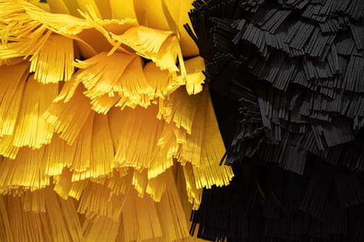 front view closeup detail of black and yellow automatic car wash system cleaning fiber sponge brushes on spinning rotor