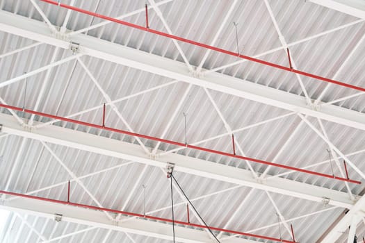 closeup perspective view of interior industrial hangar white steel sustaining roof structure