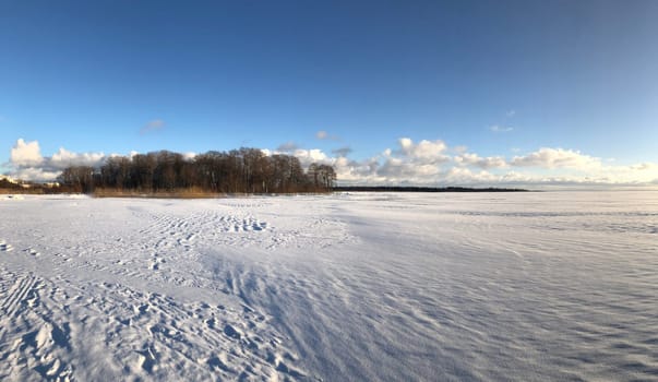 panorama frozen white lake, blue sky, sunny day, landscape