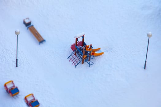 children's playground empty winter aerial view, tilt shift