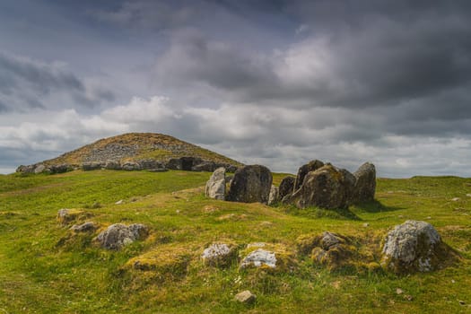 Ancient, dating back to 3000 BCE, neolithic burial chambers and stone circles of Loughcrew Cairns with dramatic, dark sky in County Meath, Ireland