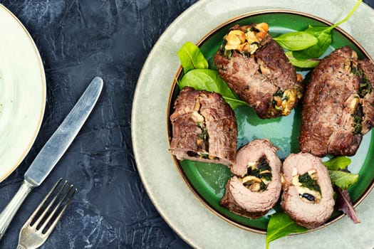 Beef rolls stuffed with mushrooms and herbs. Roasted meat, meatloaf